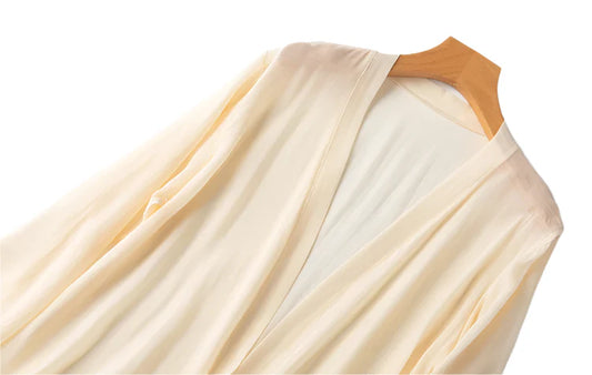 Woman wearing ivory silk kimono robe on warm summer morning
