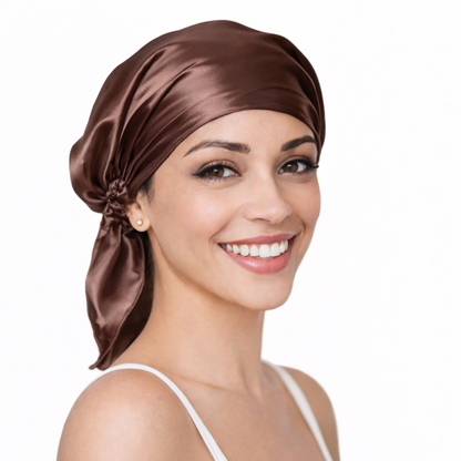 Woman wearing a brown silk headscarf on a white background