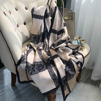 Beige and black lace scarf draped over a chair with a handbag in the background.
