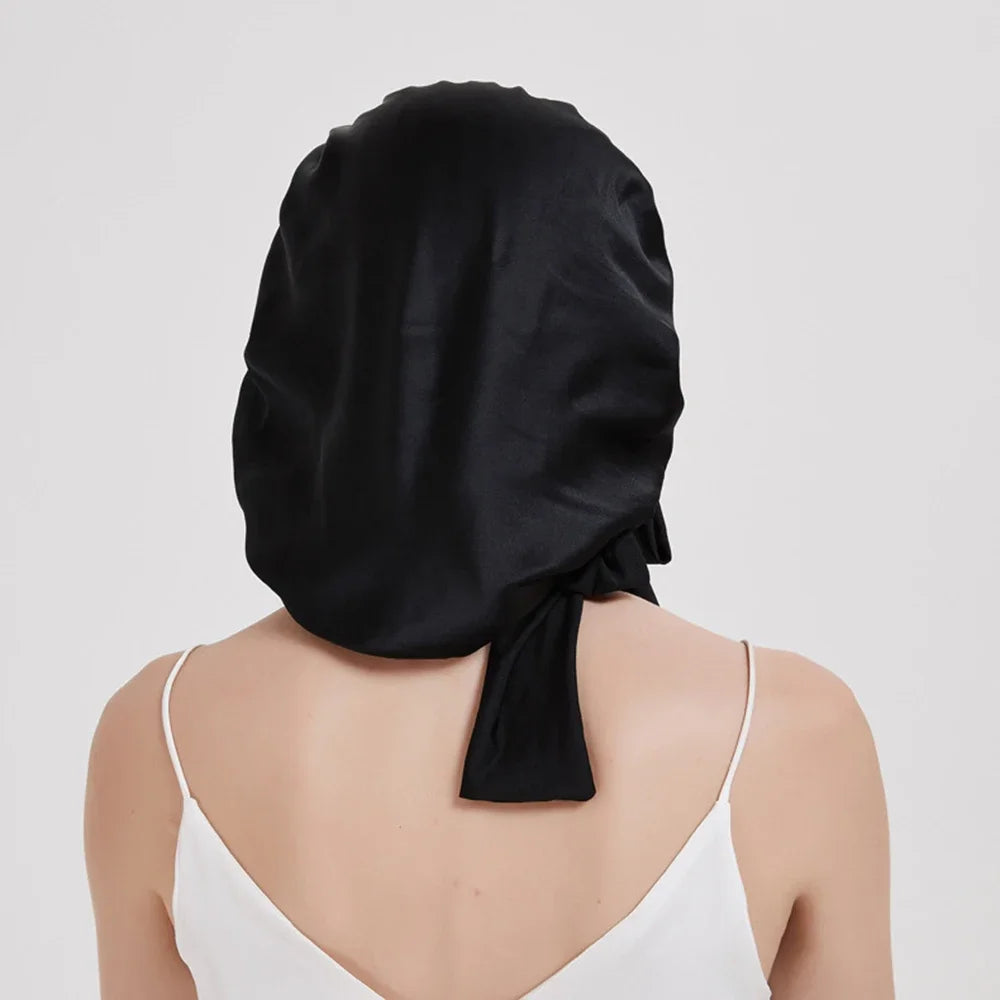 Pure mulberry silk sleeping bonnet designed to protect curly and textured hair overnight