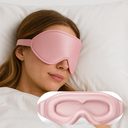 Woman wearing a pink sleep mask with another pink sleep mask in front of her.